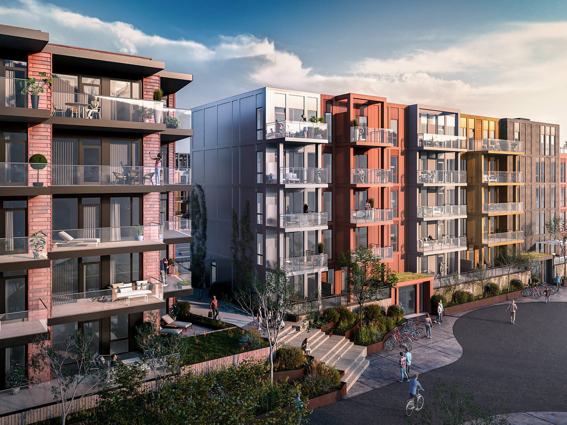 A  rendering of Bryggebyen. The photo shows a residential complex by the waterfront, featuring several multi-story buildings with large balconies. The buildings have a variety of colors, including shades of red, yellow, and gray.